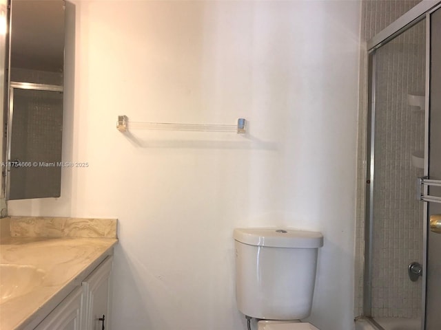 full bath with toilet, a stall shower, and vanity