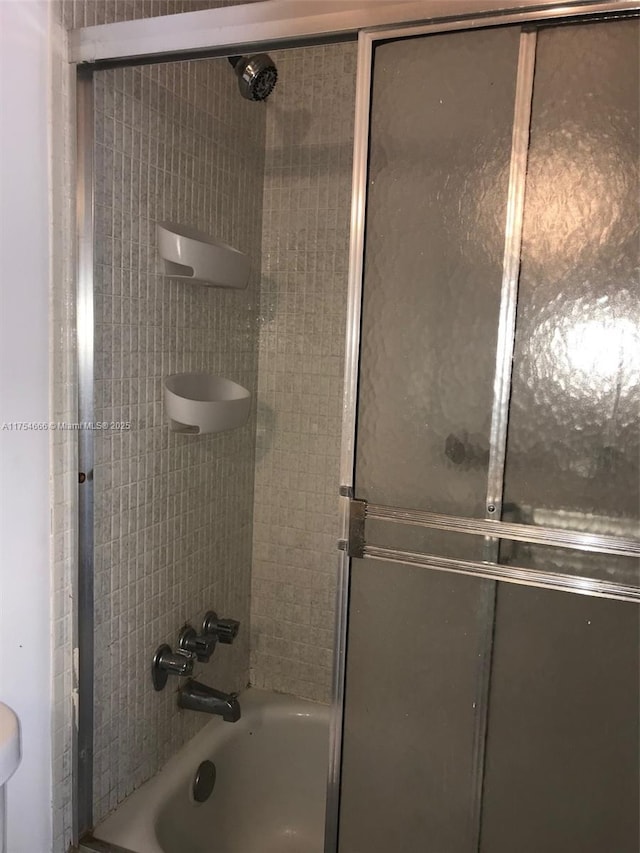 full bath with shower / bath combination with glass door