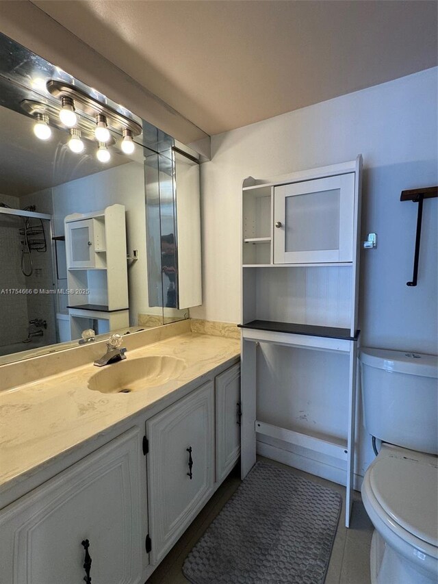 851 Three Islands Blvd Unit 411, Hallandale Beach, FL 33009 - full bathroom featuring toilet, a shower stall, vanity, and tile patterned flooring