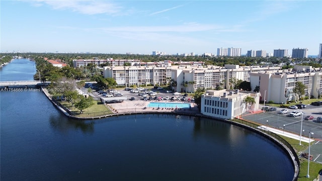 drone / aerial view featuring a view of city and a water view