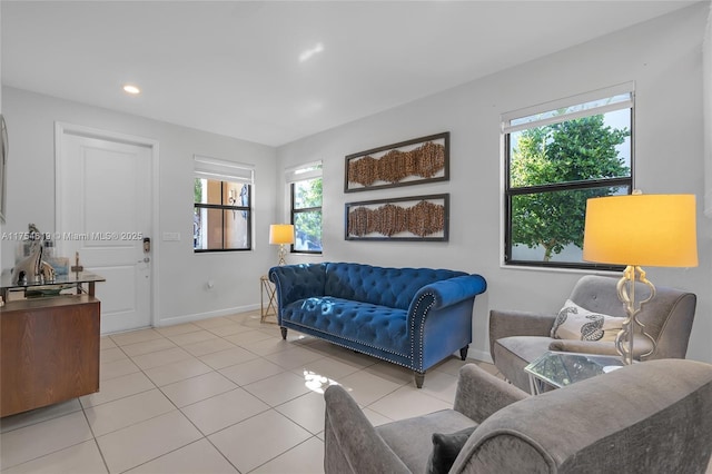 living room with recessed lighting, a healthy amount of sunlight, baseboards, and light tile patterned flooring