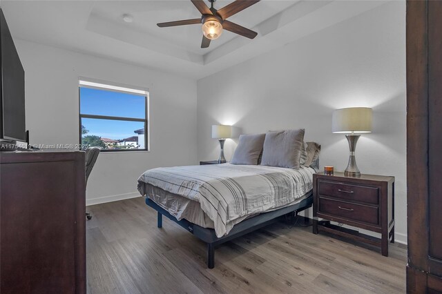 25340 SW 116th Ave, Homestead, FL 33032 - bedroom with a ceiling fan, baseboards, a raised ceiling, and wood finished floors