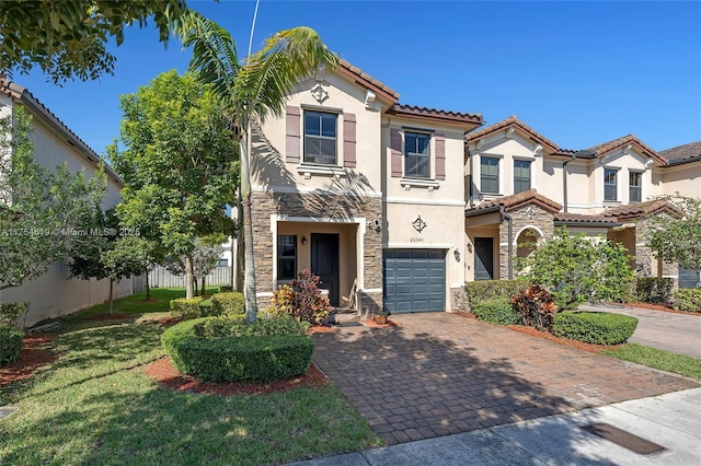 25340 SW 116th Ave, Homestead, FL 33032 - mediterranean / spanish house with decorative driveway, stucco siding, fence, a garage, and stone siding