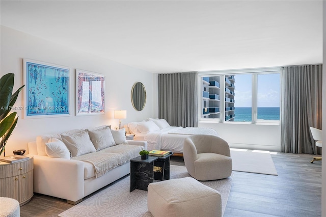 living room featuring a water view and wood finished floors