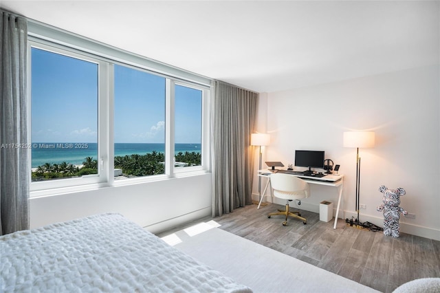 bedroom featuring baseboards and wood finished floors