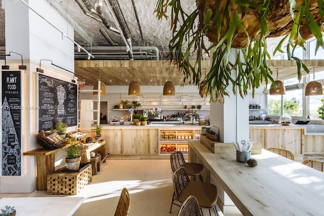 kitchen featuring concrete flooring and light brown cabinetry