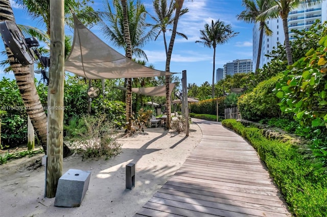 surrounding community with a view of city and a pergola