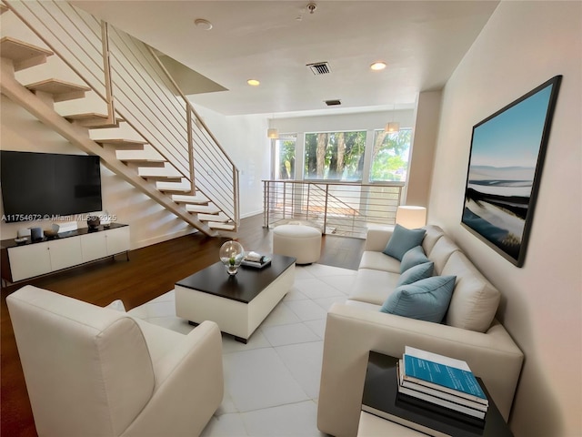 living area with visible vents, stairway, and recessed lighting