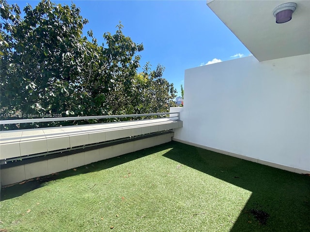 view of yard with a balcony