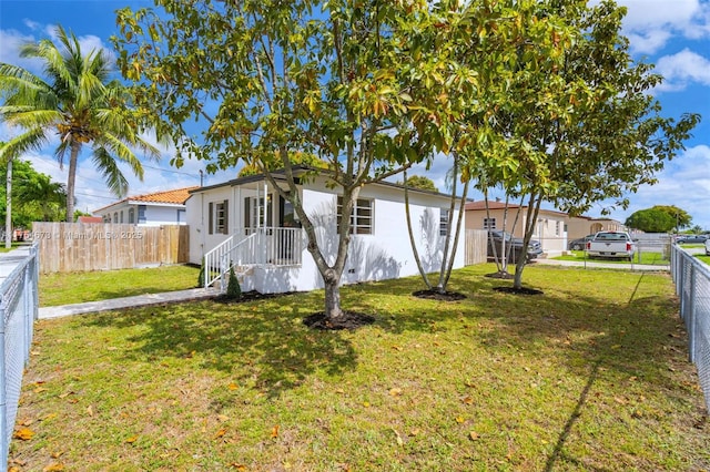 view of front of house with a front lawn and a fenced backyard