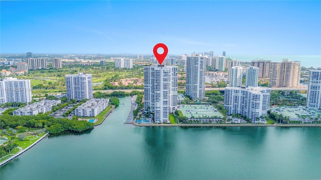 birds eye view of property with a water view and a city view