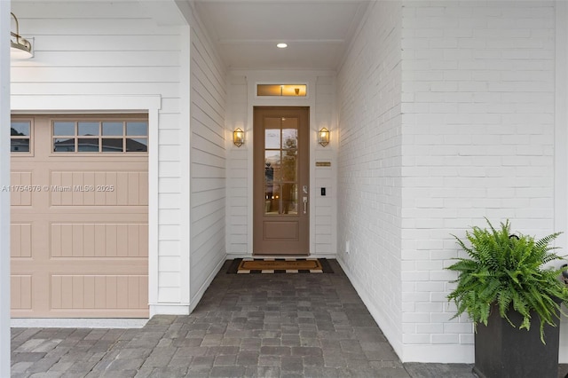 entrance to property featuring brick siding