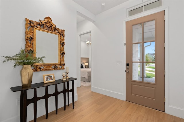 entryway featuring light wood-style floors and baseboards