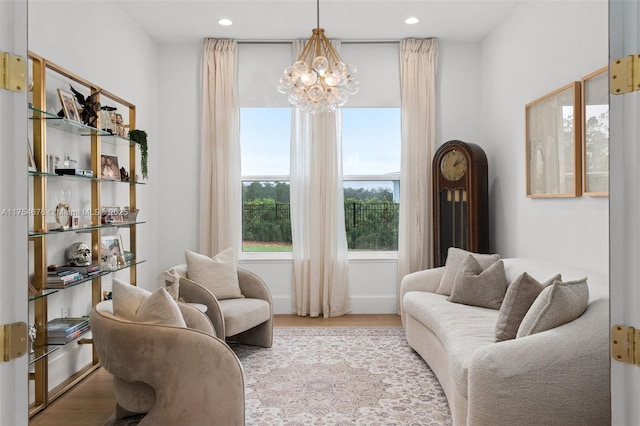 living area featuring recessed lighting, an inviting chandelier, and wood finished floors