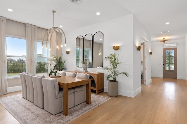 dining space with light wood finished floors, baseboards, visible vents, and recessed lighting