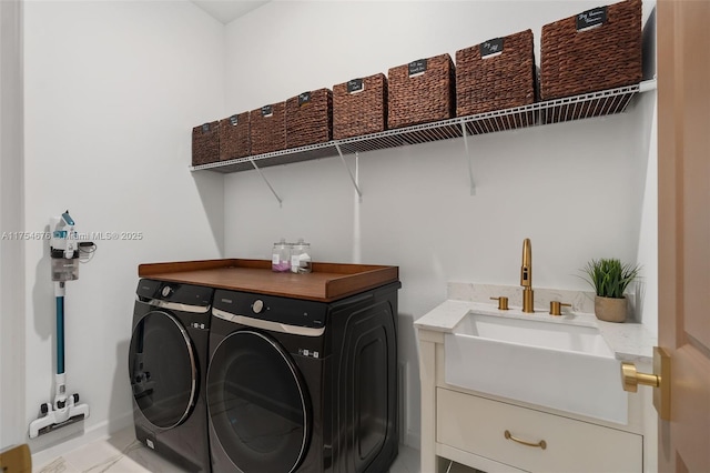 laundry room with laundry area, a sink, and washing machine and clothes dryer