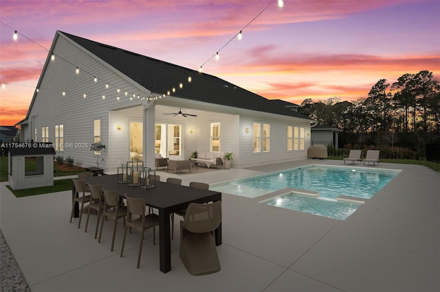 view of pool with a ceiling fan, fence, a patio area, a pool with connected hot tub, and outdoor lounge area