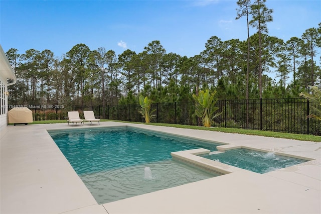 view of pool featuring a patio, a fenced backyard, and a pool with connected hot tub