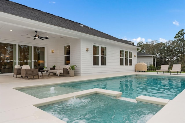 view of swimming pool featuring a patio, a pool with connected hot tub, outdoor lounge area, a ceiling fan, and fence