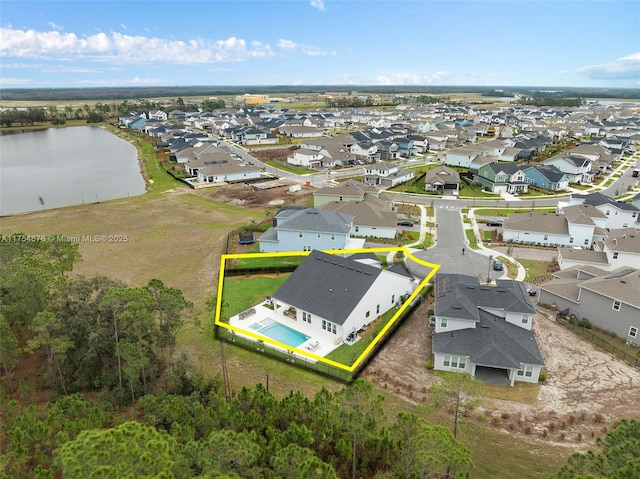 birds eye view of property with a residential view and a water view