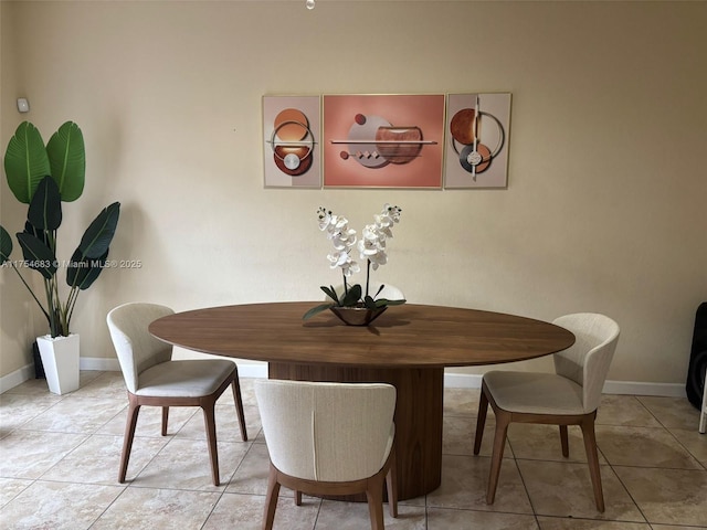 dining room featuring tile patterned flooring and baseboards