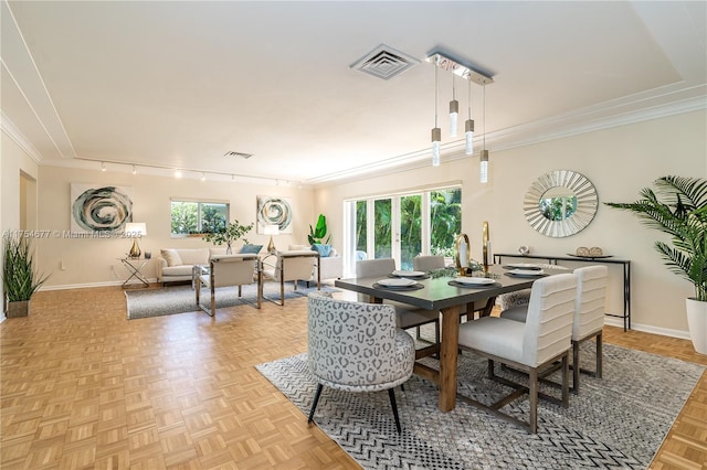 dining space with visible vents, baseboards, ornamental molding, and track lighting