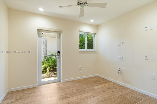 spare room featuring recessed lighting, baseboards, and light wood-type flooring
