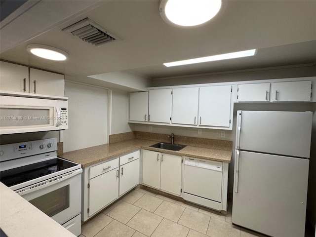 851 Three Islands Blvd Unit 218, Hallandale Beach, FL 33009 - kitchen with white appliances, a sink, light tile patterned floors, white cabinetry, and light countertops