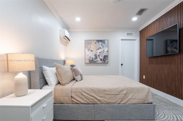 bedroom with visible vents, crown molding, and a wall unit AC