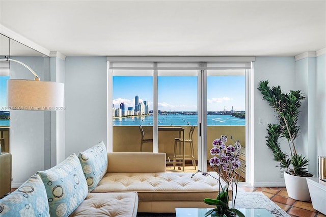 tiled living room featuring a view of city, floor to ceiling windows, and a wealth of natural light