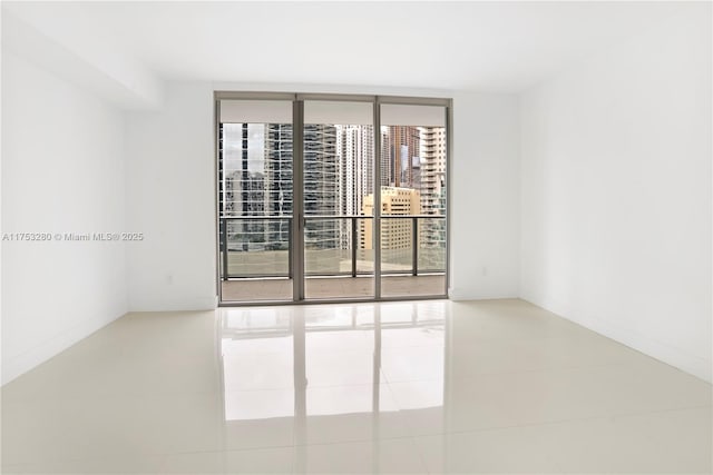 tiled spare room with expansive windows