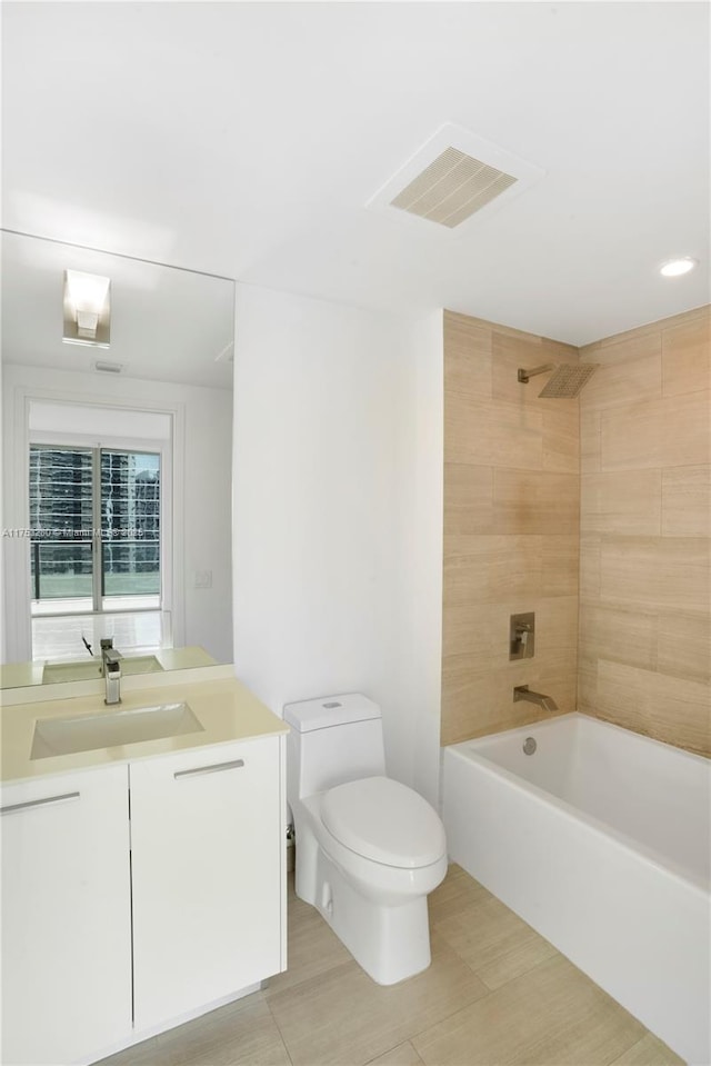 bathroom with visible vents, shower / bathing tub combination, vanity, and toilet