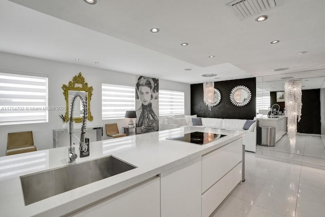 kitchen with recessed lighting, white cabinets, visible vents, and a sink