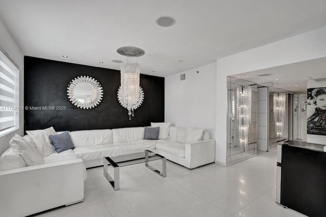 living area featuring an accent wall, recessed lighting, visible vents, and tile patterned floors