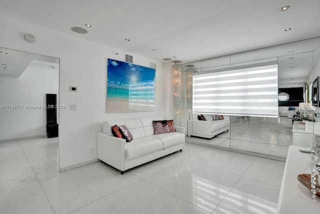 living room with baseboards, tile patterned flooring, visible vents, and recessed lighting