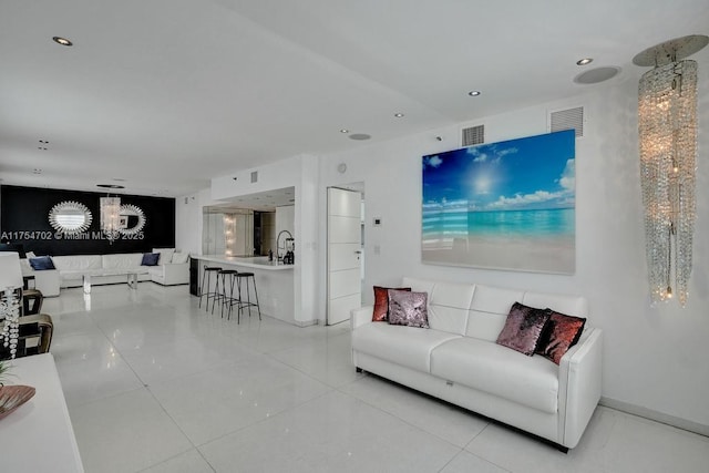 living area featuring light tile patterned flooring, visible vents, and recessed lighting