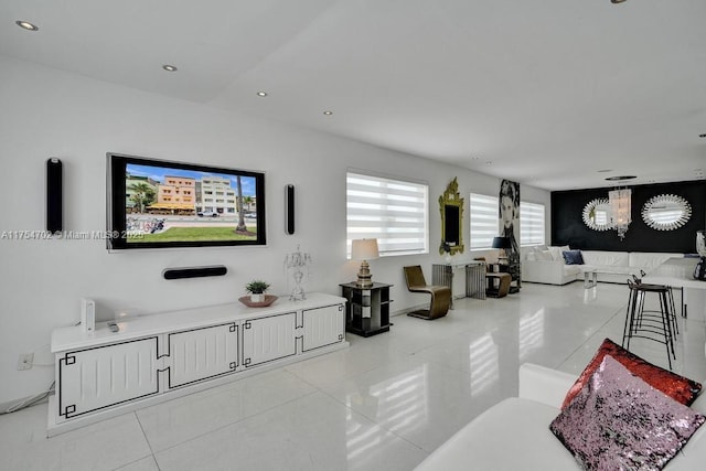 living area with light tile patterned flooring, an inviting chandelier, and recessed lighting