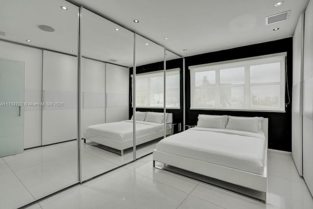 bedroom featuring tile patterned flooring, visible vents, and recessed lighting