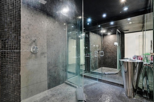 full bath with a stall shower, vanity, and tile patterned floors