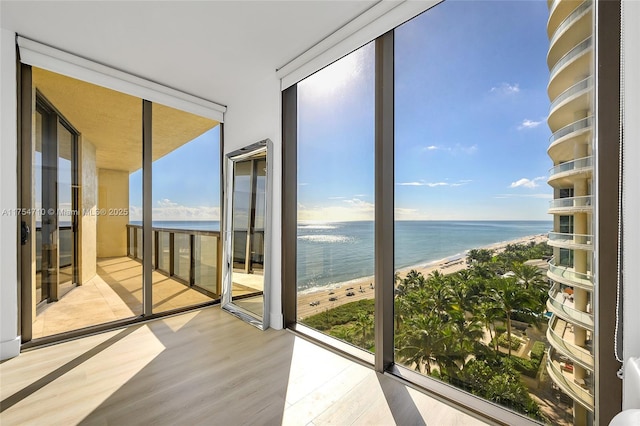 interior space with a water view and a beach view