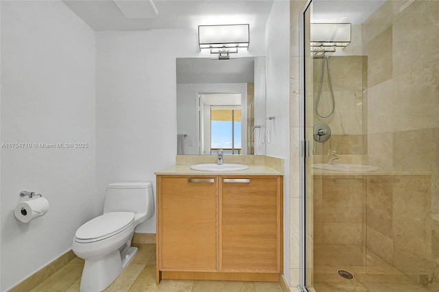 full bathroom featuring baseboards, toilet, tile patterned floors, vanity, and a shower stall