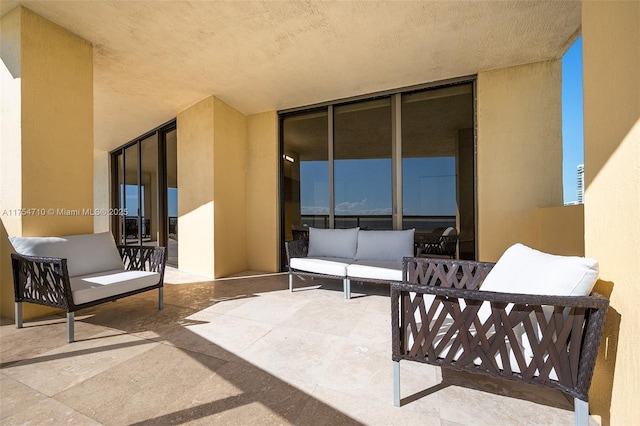 balcony with a patio area and an outdoor living space