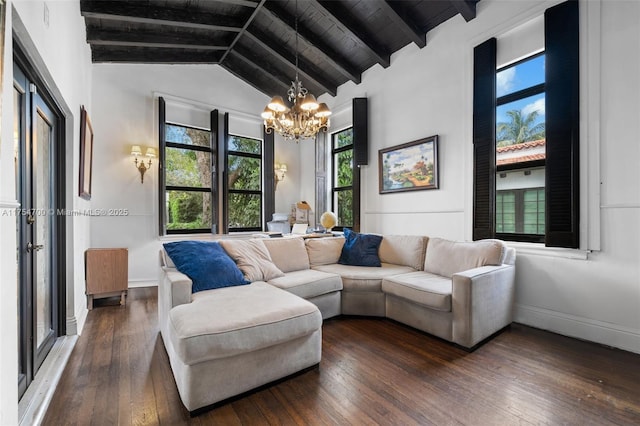 living room with dark wood finished floors, vaulted ceiling with beams, an inviting chandelier, wooden ceiling, and baseboards