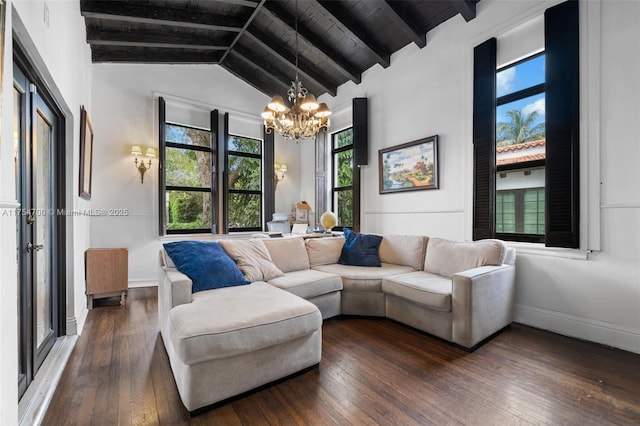 living area with vaulted ceiling with beams, baseboards, dark wood-style flooring, and a chandelier