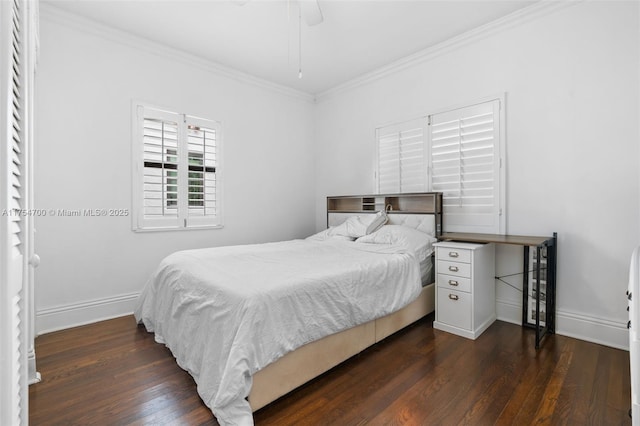 bedroom featuring crown molding, dark wood-type flooring, and baseboards