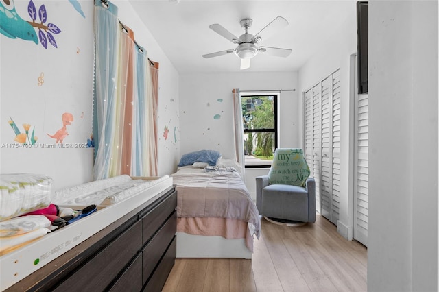 bedroom with light wood-style floors and a ceiling fan