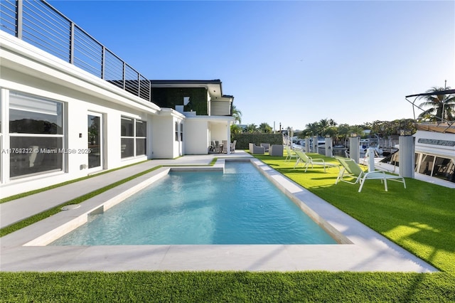 pool featuring a yard and a patio area