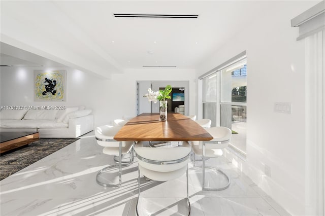 dining area with marble finish floor and visible vents