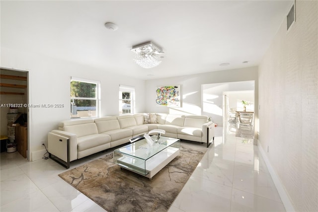 living room with marble finish floor, visible vents, and baseboards