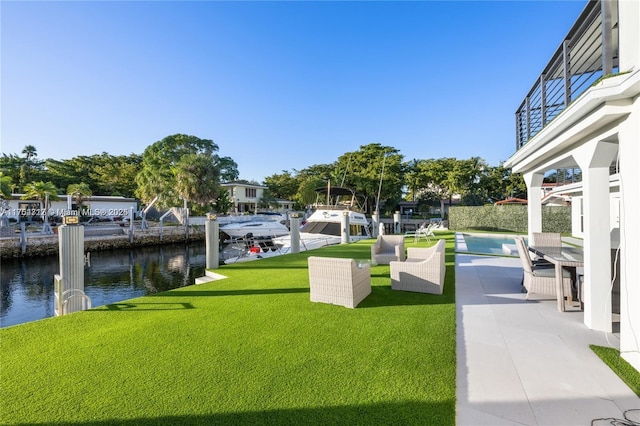 surrounding community with a yard, a boat dock, and a water view